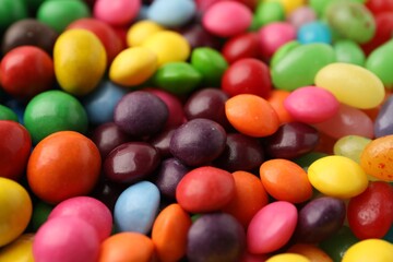 Many delicious colorful candies as background, closeup