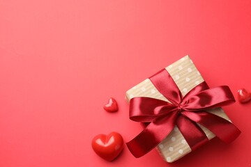 Beautiful gift and decorative hearts on red background, flat lay with space for text. Saint Valentine's day
