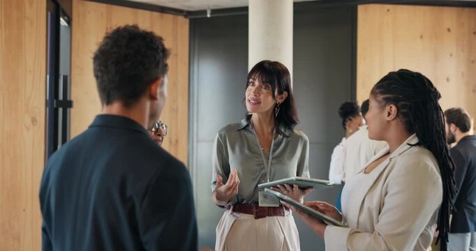 Hallway, speaking or team with tablet for meeting schedule, delegate tasks or roles reminder for proposal. Discussion, motivation or people together for pitch, action plan or tech to explain agenda