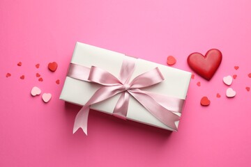 Saint Valentine's day. Beautiful gift and decorative hearts on pink background, flat lay