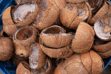 Close-up Texture of Brown Coconut Shells Piled Up. Natural Byproduct and Tropical Waste.