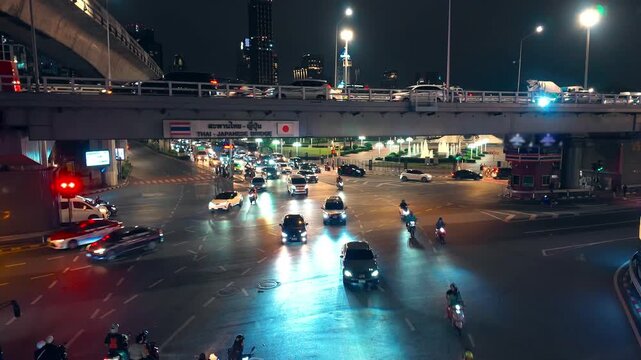 timelapse of cars traffic at night at big city, rush hour at urban roads, vehicles driving by crossroads at highway intersection, Thai Japanese bridge, Bangkok, Thailand 4k hyperlapse