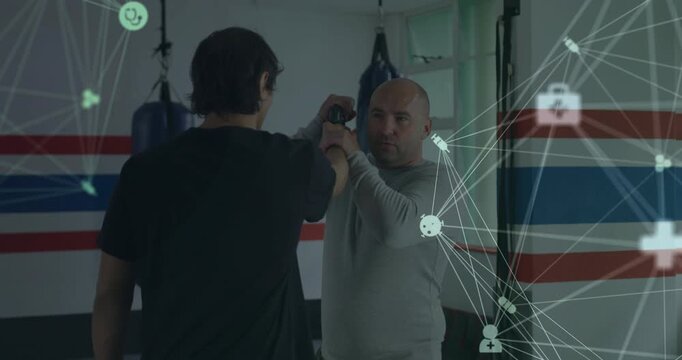Trainer holding knife near defender head, defender blocking then disarming, right net overlay
