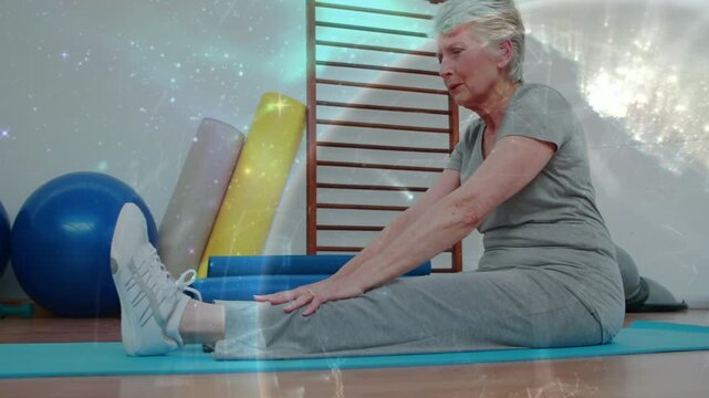 Senior reaching ankles flowing into holding health hamstring stretch on mat with overlay