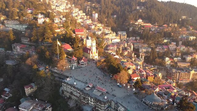 Beautiful drone view of the ridge shimla including christ church and people are walking on mall road shimla. Heavy traffic on shimla kufri highway and car are moving to kufri from shimla. 