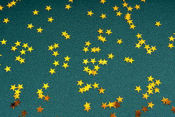 Gold star shape on green background Christmas background