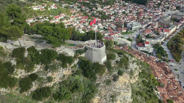 Aerial view of Berat with the Albanian flag flying proudly on the hilltop platform overlooking the city and Osum River.
