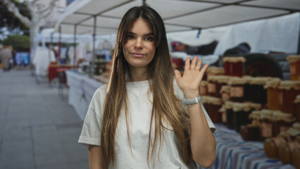 Woman smiling at an outdoor market with white stands in a lively urban street setting, capturing vibrant city life with displays of assorted goods.