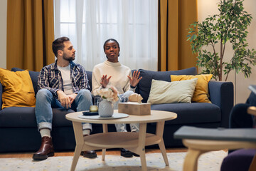 Diverse couple discussing relationship problems in psychotherapy session