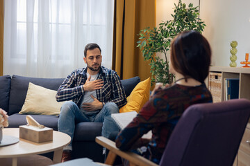Man practicing breathing exercise during psychotherapy session