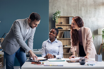 Business people discussing project data in modern office