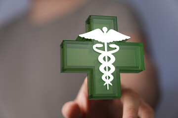 Abstract image showing Caduceus with a cross shape symbolizing health, care, and medical concepts,...
