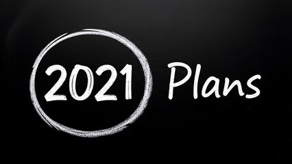 Chalk drawing of 2021 plans circled on a dark blackboard symbolizing future goals and new beginnings