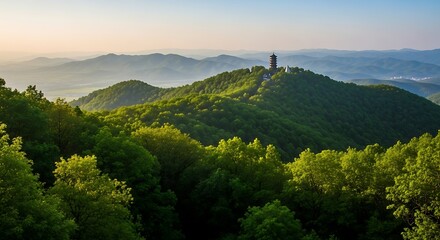A verdant, forested landscape features a towering structure atop a lush, green mountain, bathed in the soft glow of dawn. Rolling hills disappear into the horizon
