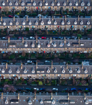 Aerial view of neat rows of houses with slate roofs and dormer windows create a rhythmic pattern, punctuated by colorful cars and small gardens, Edinburgh, Scotland, United Kingdom.