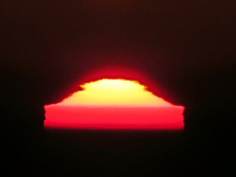 Sunrise with strong distortion of thermal inversion on a cold winter morning.