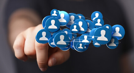 Hand pointing at connected network of people icons, representing social media, business connections, and communication. Digital design for onlin
