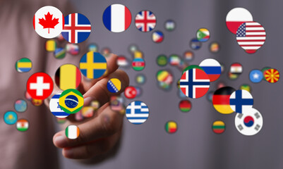Conceptual image of a hand holding various country flags, symbolizing international cooperation,...