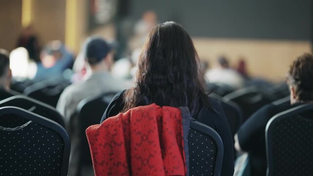 Unrecognizable business woman attending a business meeting in a spacious conference room