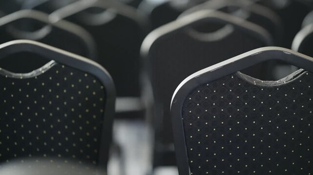 Close-up of empty seats arranged in a row in a business conference hall