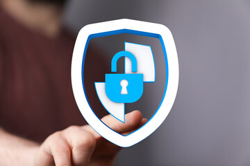 Secure digital data concept with person touching a shield with a lock, protecting private information and cybersecurity.
