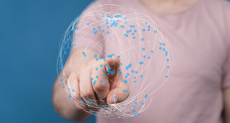 Person's hand touching a network globe illustration representing the digital world, connectivity, and communication. Symbolic image f