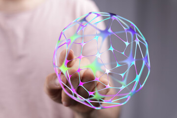 Abstract image of a hand holding a digital network globe, representing concepts like connection, technology, and global communication