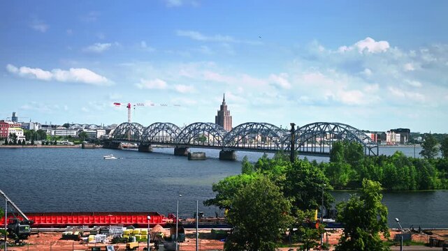Scenic river landscape of Riga in Latvia with metal bridge and vibrant urban skyline