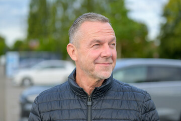 Mature Man Smiling Sideways Outdoors