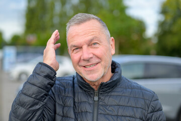 Mature Man Smiling Touching Hair