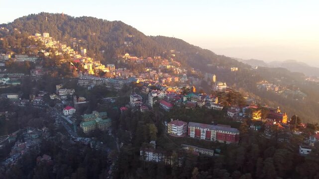 Beautiful drone view of the ridge shimla including christ church and people are walking on mall road shimla. Heavy traffic on shimla kufri highway and car are moving to kufri from shimla. 