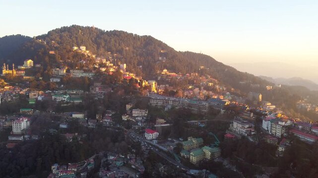 Beautiful drone view of the ridge shimla including christ church and people are walking on mall road shimla. Heavy traffic on shimla kufri highway and car are moving to kufri from shimla. 