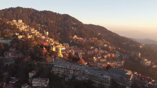 Beautiful drone view of the ridge shimla including christ church and people are walking on mall road shimla. Heavy traffic on shimla kufri highway and car are moving to kufri from shimla. 