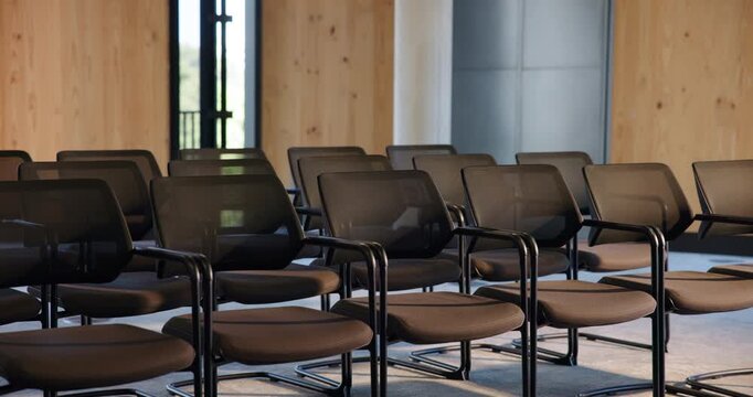 Chairs, convention and empty room for business forum, event and seminar with meeting venue. Furniture, hall and interior at conference center with rows for summit, presentation and seats for workshop