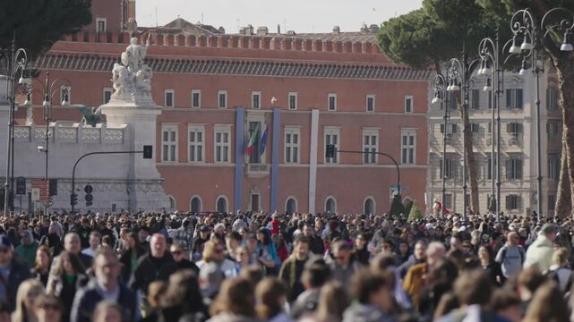 Crowd of people in Rome, Italy on street Via dei Fori Imperiali on sunny day during Eastern holidays when street is made a walkway zone, slow motion