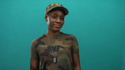 Young african american woman in camouflage uniform with dog tags necklace smiling at camera in a...