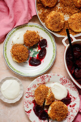 Traditional Austrian cottage cheese dumplings in breadcrumbs with plum compote and sour cream.