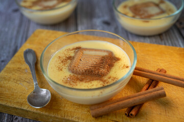 Homemade custard with cookies and cinnamon