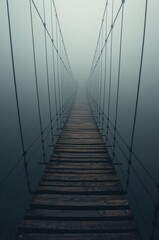Foggy suspension bridge rises overhead as rusted cables vanish into deep mysterious abyss