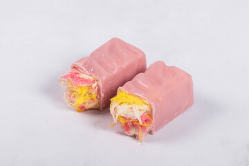 Pink chocolate candy bar. Angel Hair. With colored cotton candy. White background. Close up