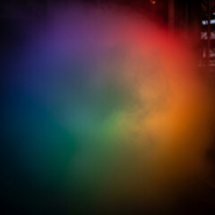 Obraz premium Vibrant rainbow smoke effect in dark background