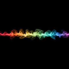 Obraz premium Vibrant rainbow smoke swirling on black background