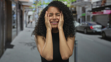 Woman distressed on urban street during daytime captures emotional intensity in public setting with...