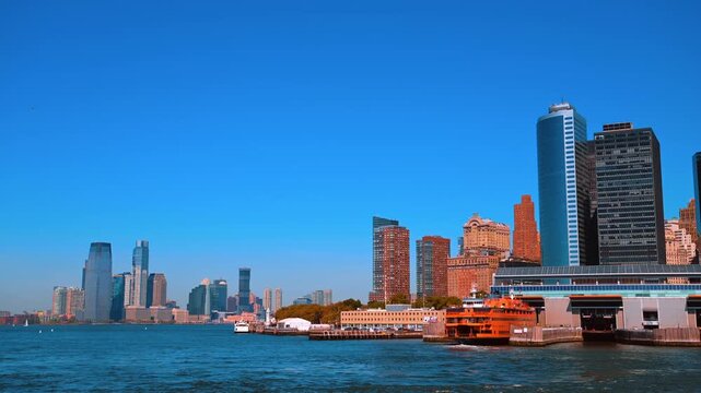 Orange ferry boat stands at Staten Island in New York, USA. Watching highlights of the borough from the riverscape.