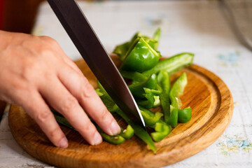 Preparing vegetables: chopping bell peppers for cooking or a healthy salad