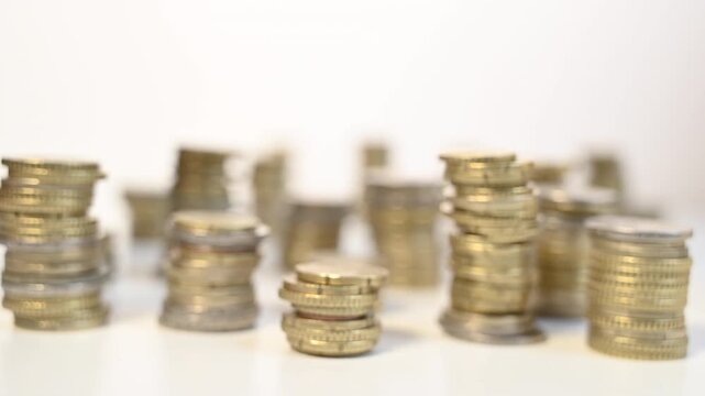 A Hand Walking Between Stacks of Cents: A Visual Metaphor for Greed, Avarice, and the Struggles of Saving