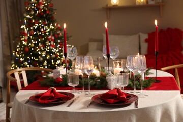Festive table setting with Christmas decor indoors