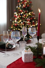 Festive table setting with Christmas decor indoors, closeup