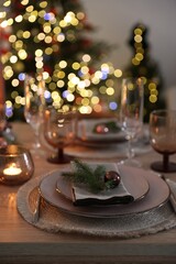 Festive table setting with Christmas decor indoors, closeup