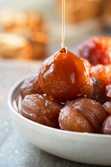 Close up of French tradition candied chestnut or marron glac&eacute;,  while syrup pouring on it. It's a confection consists of a chestnut candied in sugar syrup and glazed.
